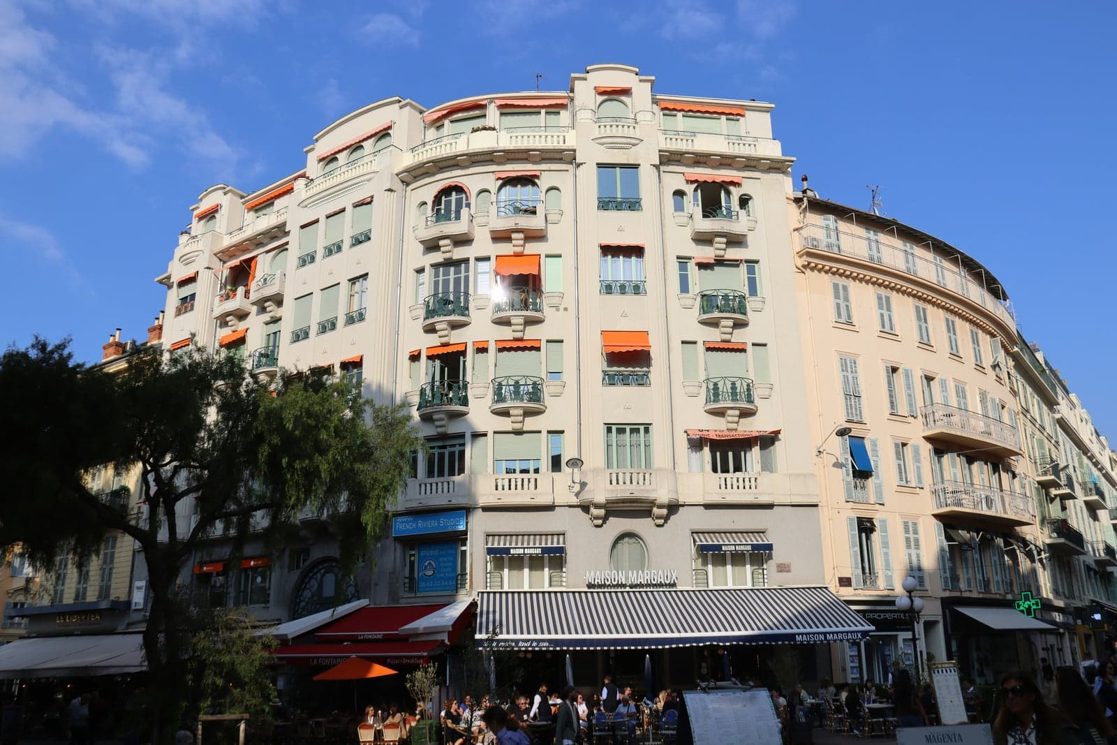 Apartment balconies above street-level shops and restaurants in a mixed-use building