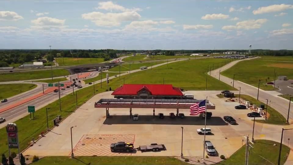 Aerial view of a gas station with a fuel canopy and convenience store